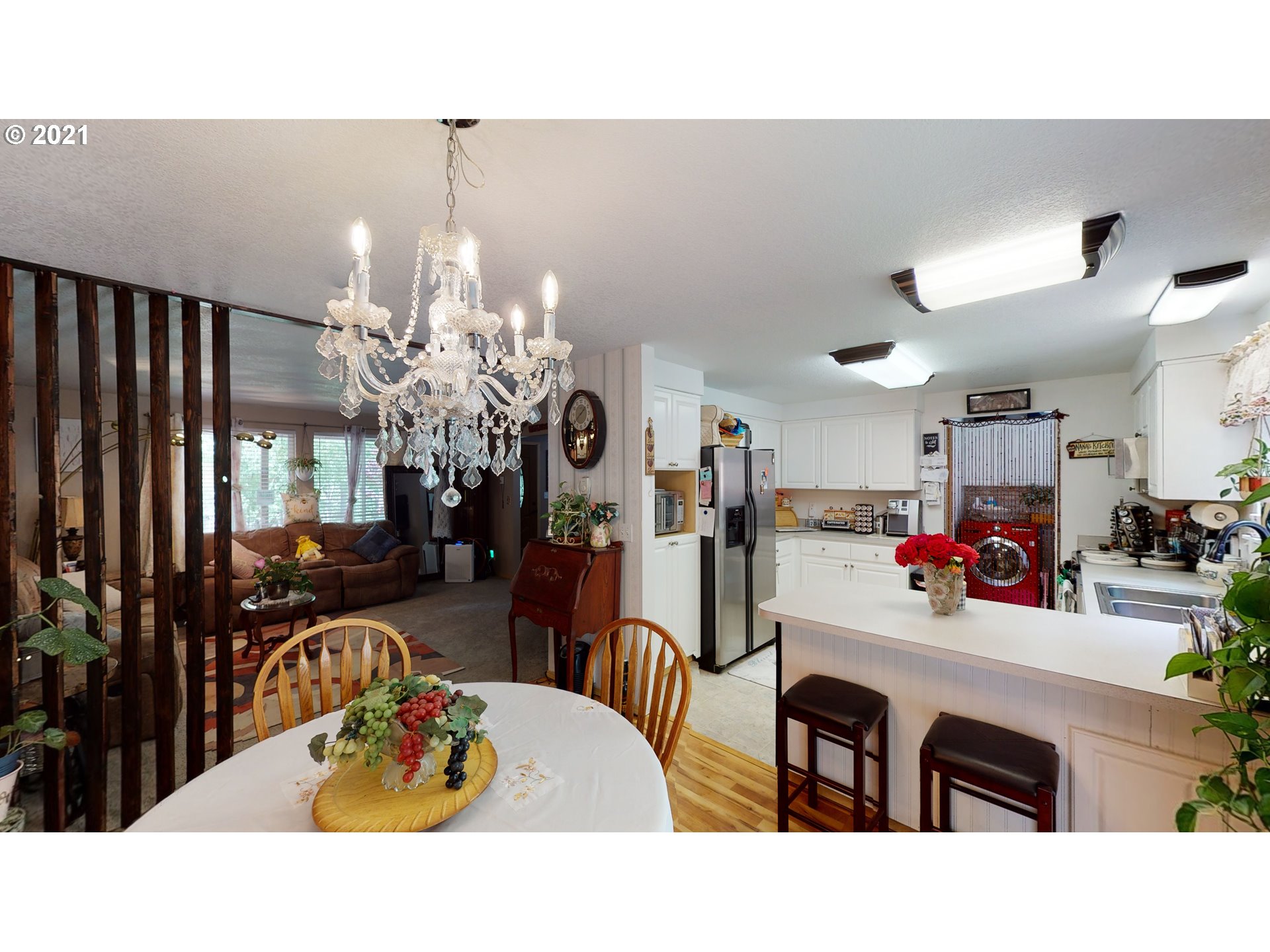1803 Byron Creek Road Winston, OR 97496 - Photo 13 of 32 a living room with furniture a chandelier and kitchen view