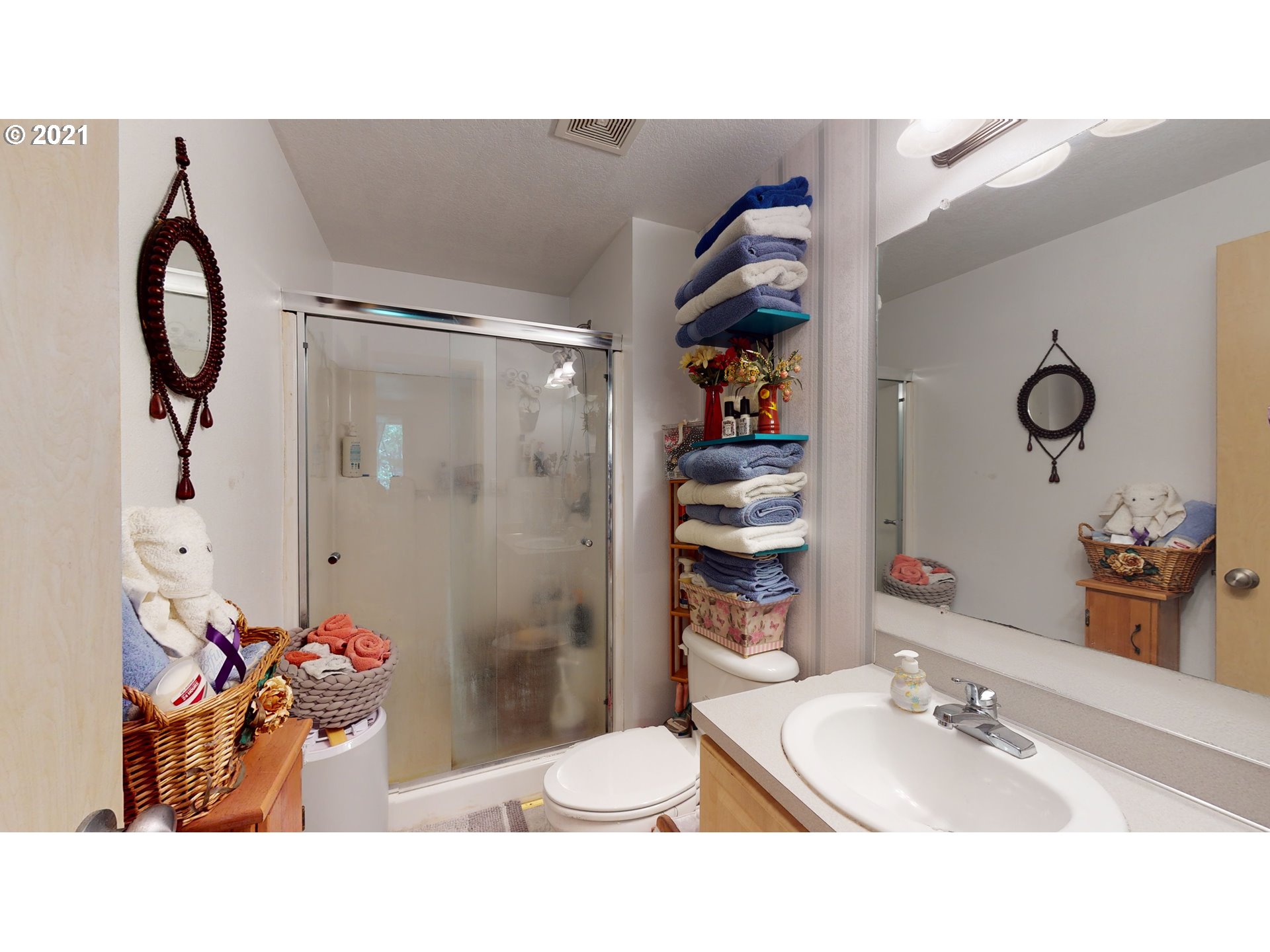 1803 Byron Creek Road Winston, OR 97496 - Photo 18 of 32 a bathroom with a sink mirror and a shower curtain
