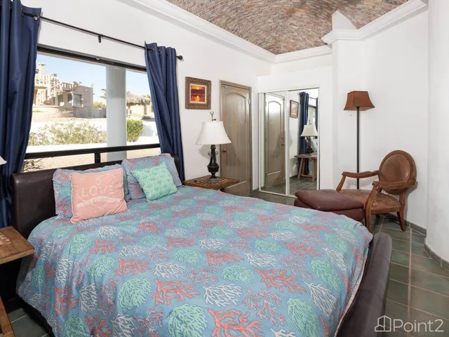 a bed sitting in a bedroom next to a window