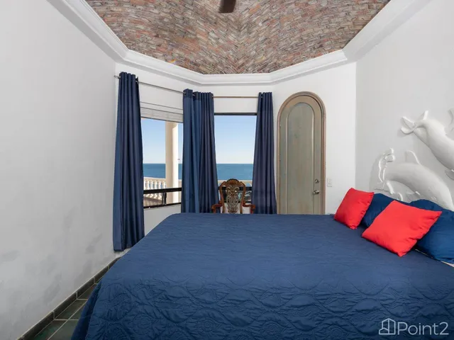 a bedroom with a bed and a painting on the wall