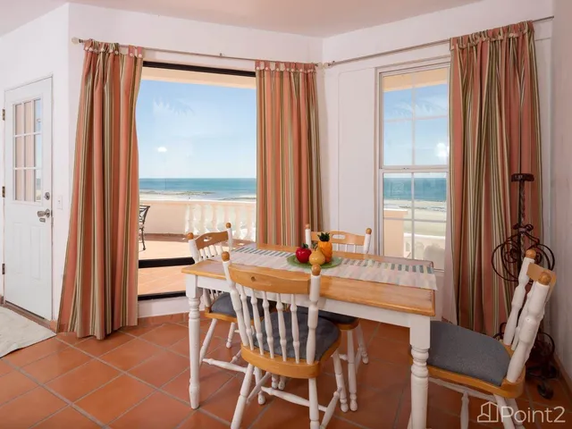 a kitchen with stainless steel appliances granite countertop a table and chairs