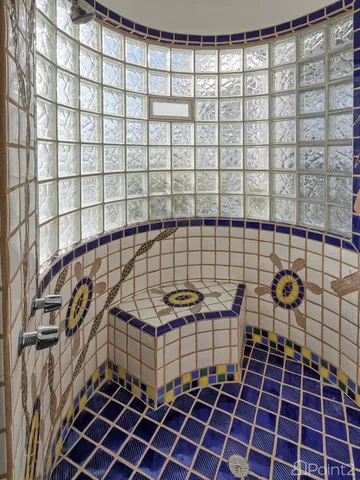 a room with cabinets and view of kitchen