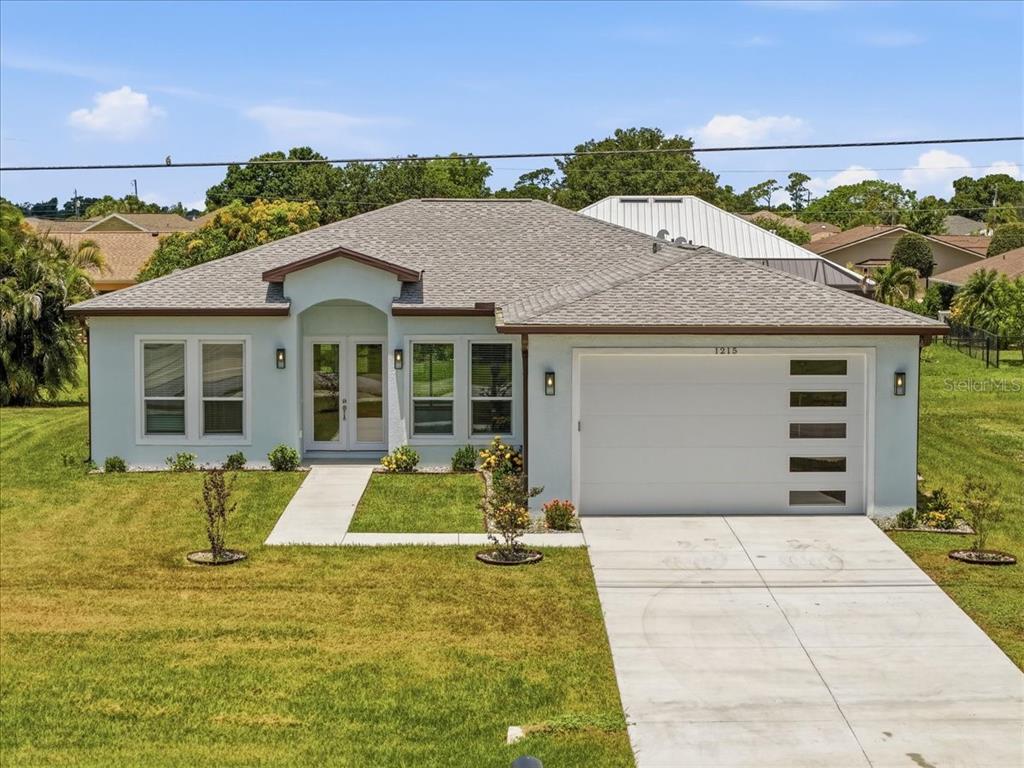 1215 Rio De Janeiro Avenue Punta Gorda, FL 33983 - Photo 1 of 65 a front view of a house with a yard