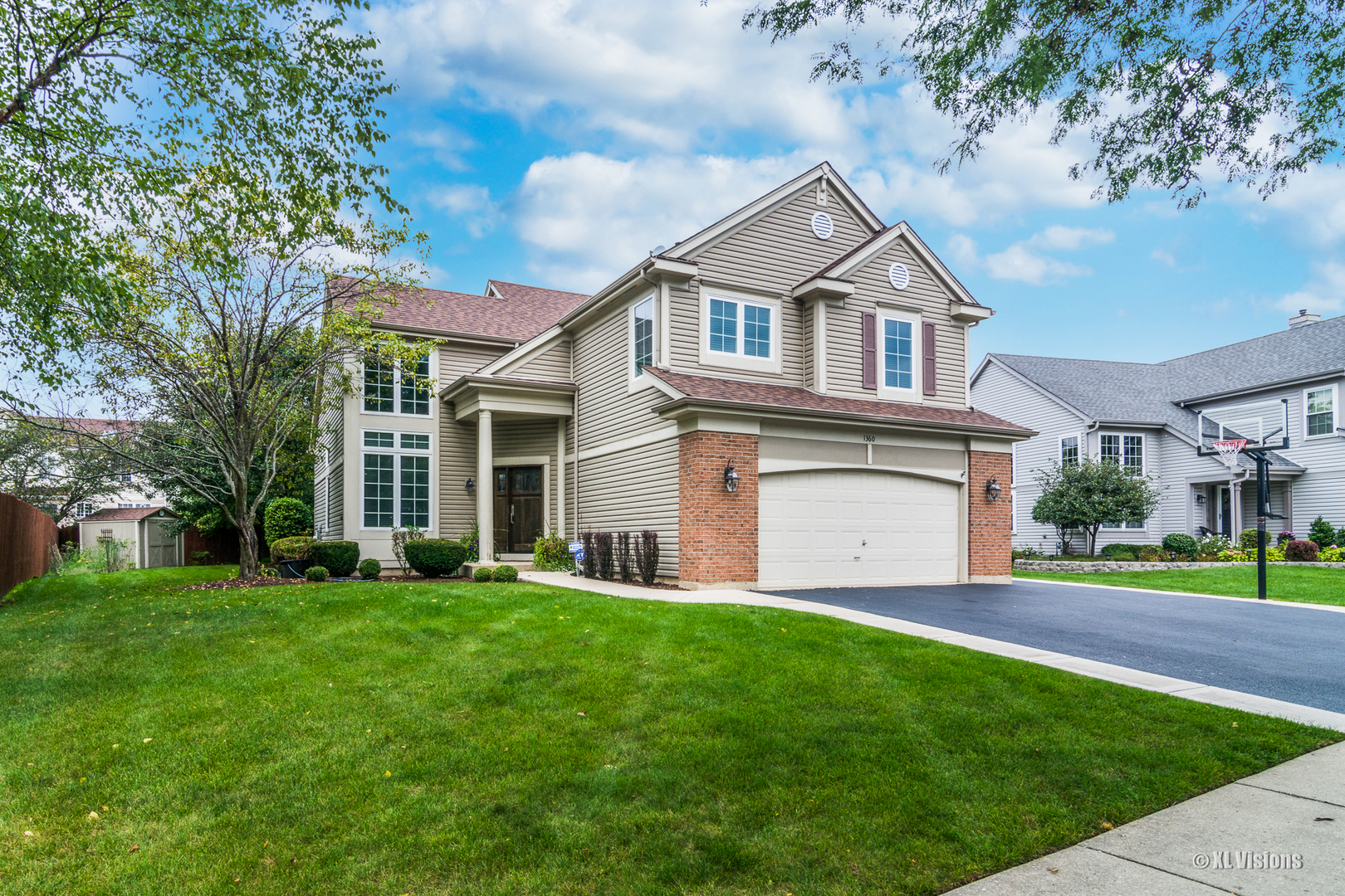 1360 Beacon Lane Bartlett, IL 60103 - Photo 1 of 26 a front view of a house with a yard and trees