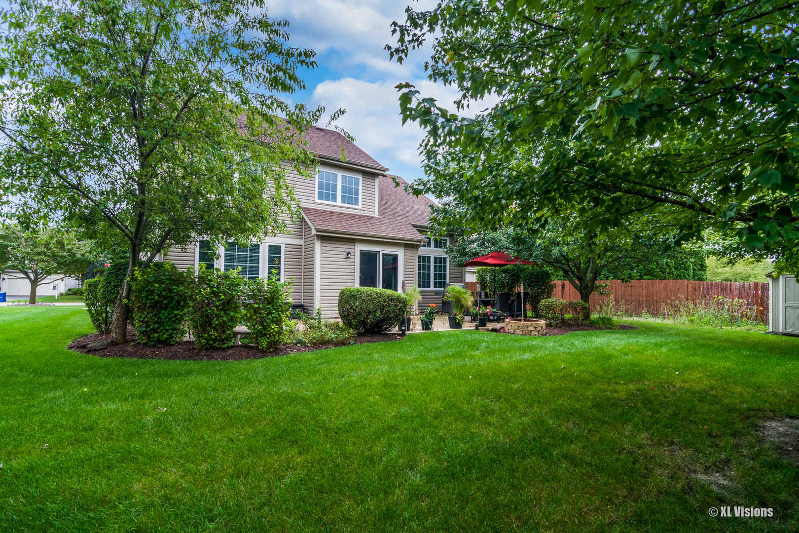 1360 Beacon Lane Bartlett, IL 60103 - Photo 3 of 26 a front view of a house with a garden and porch