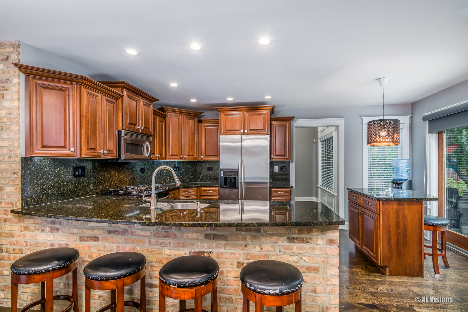 1360 Beacon Lane Bartlett, IL 60103 - Photo 7 of 26 a kitchen with cabinets a sink and chairs