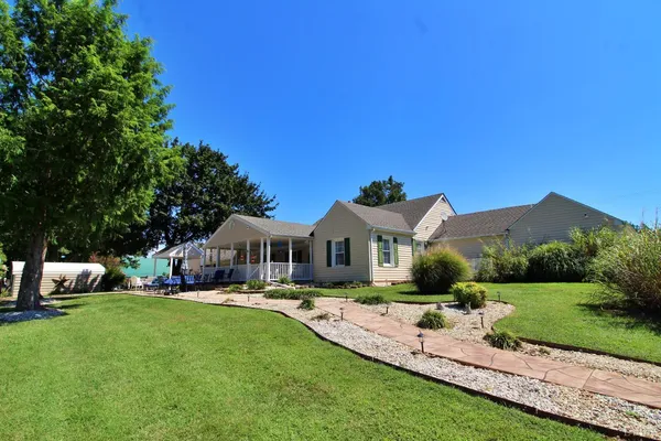 a view of a outdoor space with deck and tree