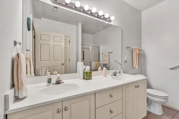 a bathroom with a sink double vanity and a mirror