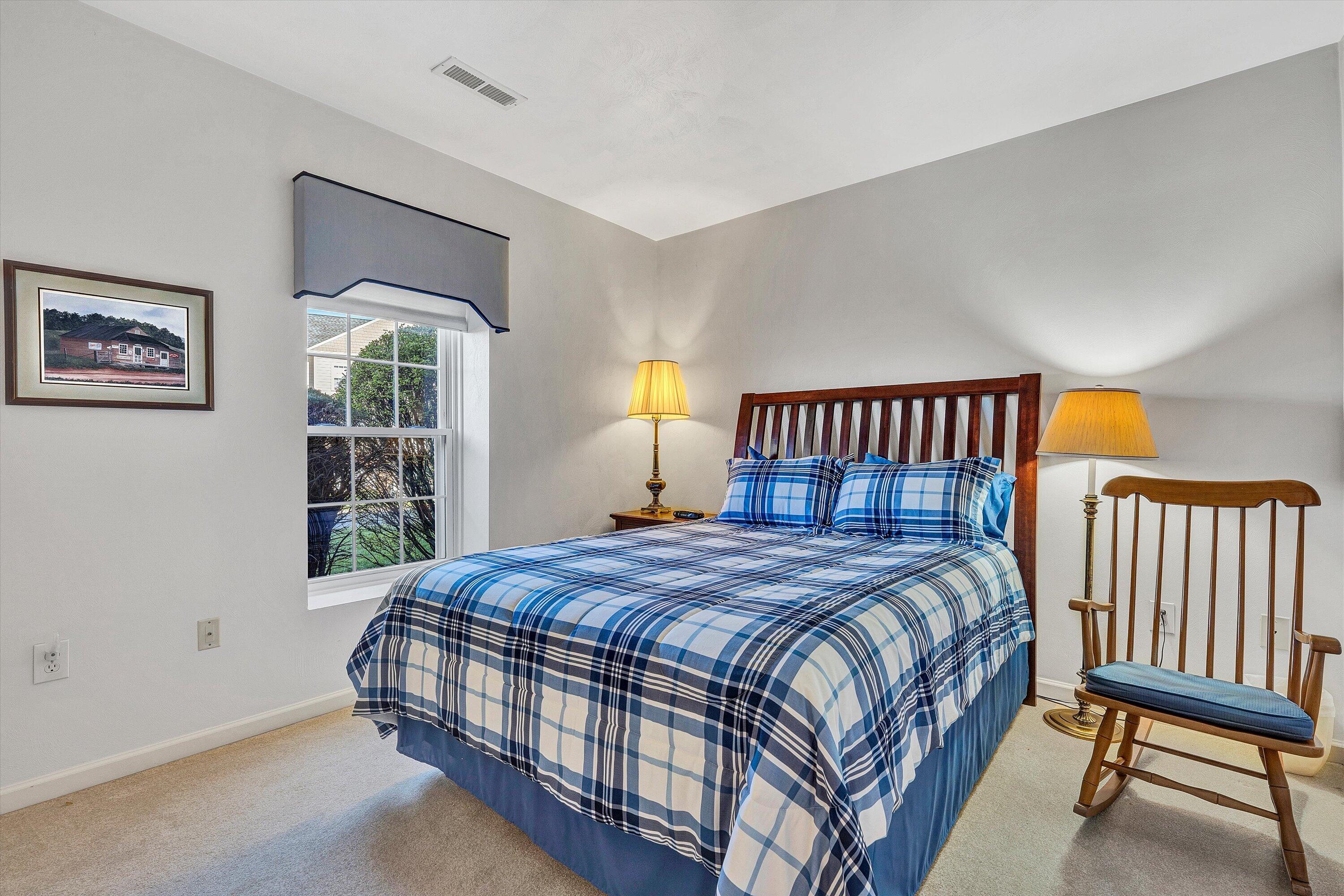 4434 Pheasant Ridge Road, Unit 105 Roanoke, VA 24014 - Photo 15 of 17 a bedroom with a bed a painting on the wall and a window