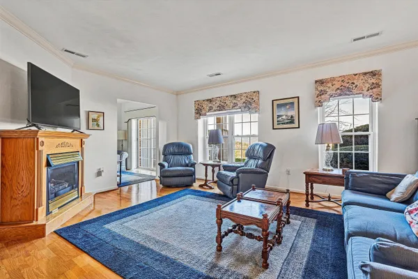 a living room with furniture flat screen tv and a fireplace