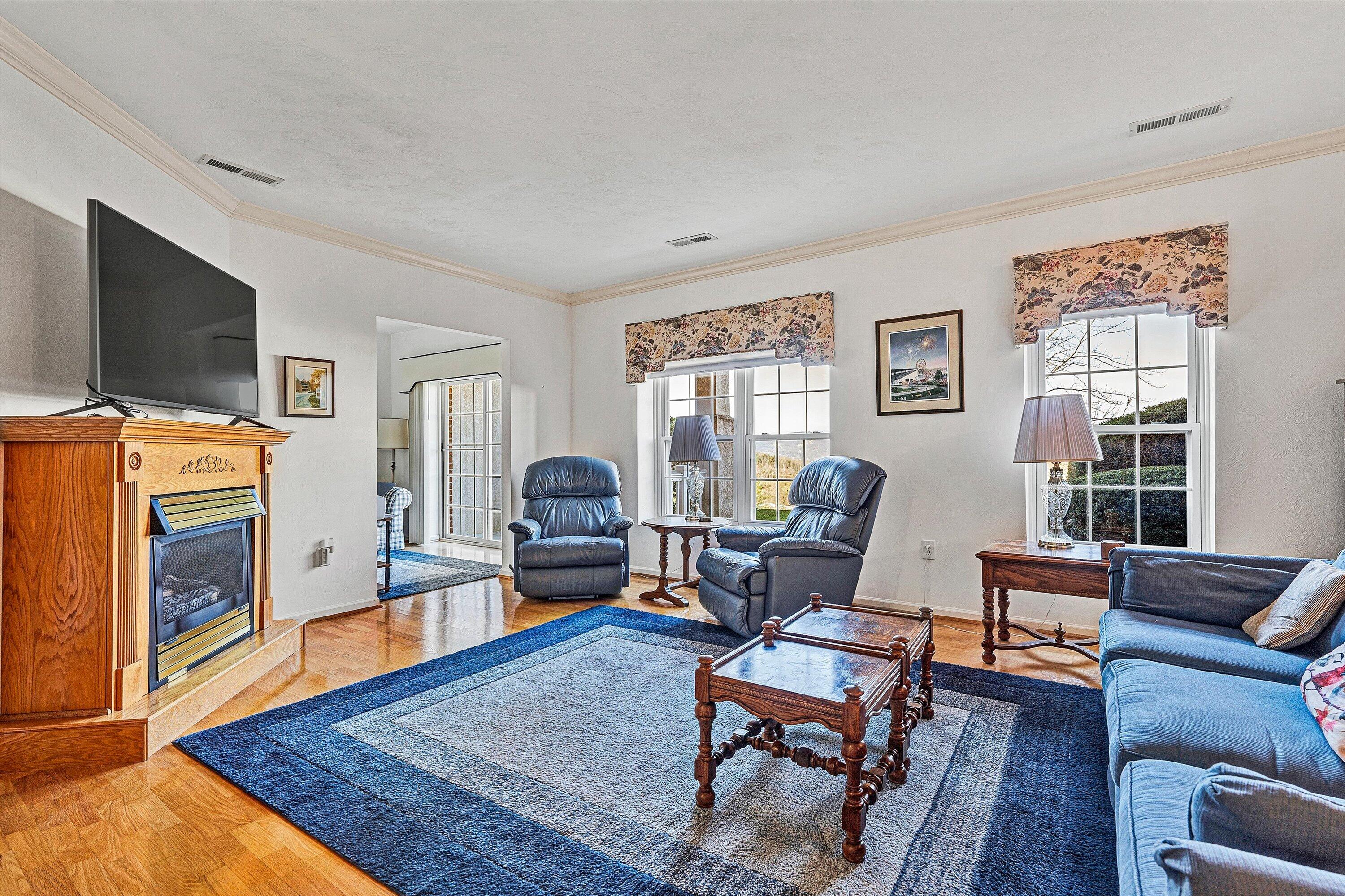 4434 Pheasant Ridge Road, Unit 105 Roanoke, VA 24014 - Photo 8 of 17 a living room with furniture flat screen tv and a fireplace