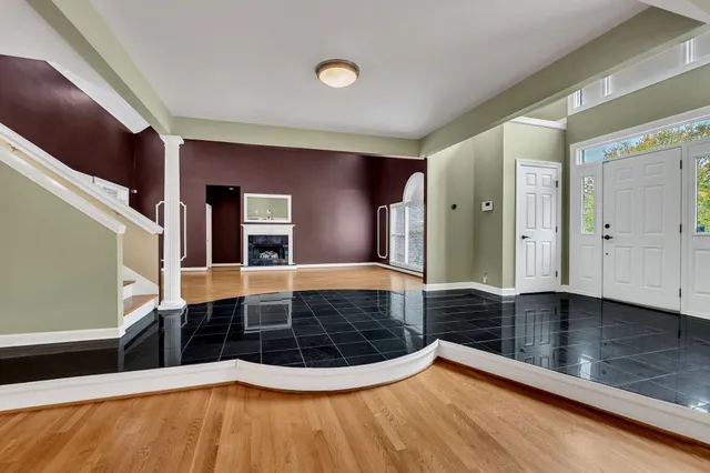 a view of an entryway with wooden floor
