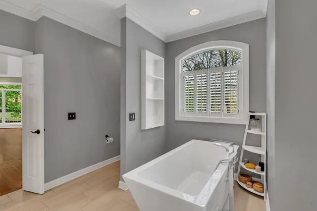 a room with wooden floor and lots of cabinets