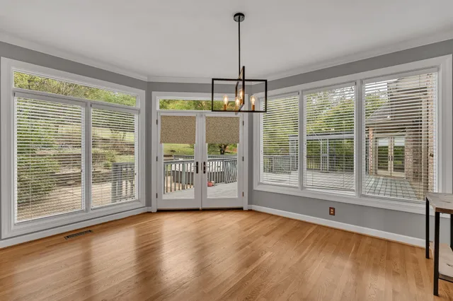 a view of a field with trees in the background