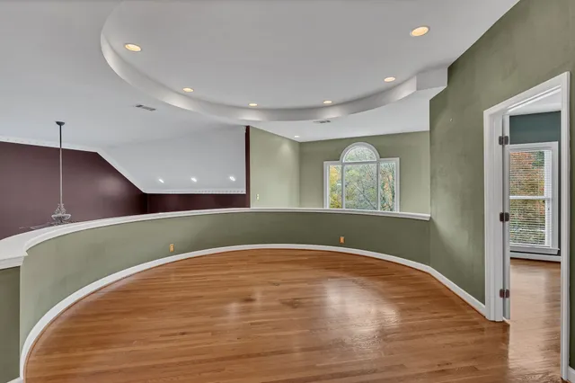 an aerial view of residential house with outdoor space and trees all around