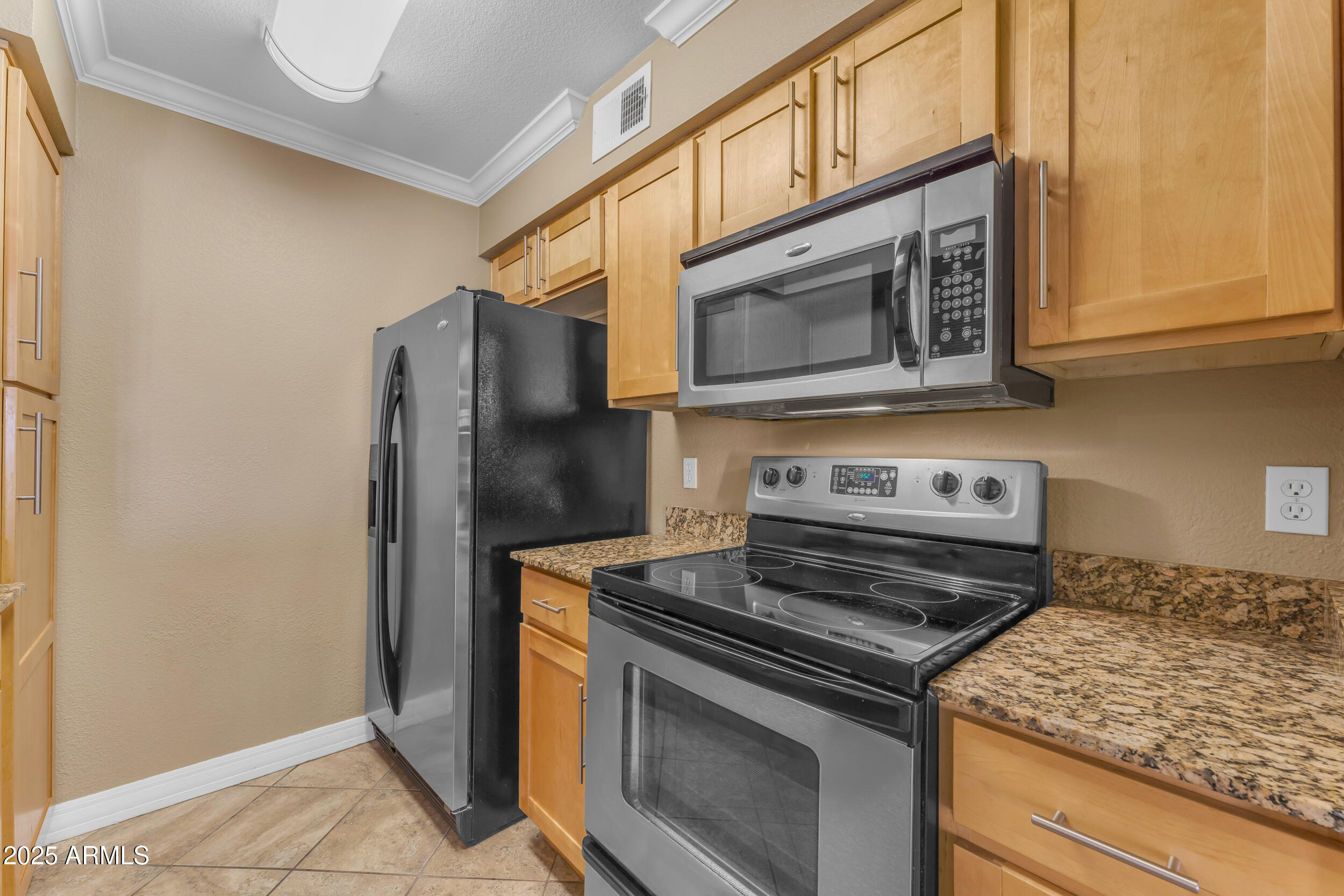 2025 East Campbell Avenue, Unit 140 Phoenix, AZ 85016 - Photo 14 of 52 a kitchen with stainless steel appliances granite countertop white cabinets and a stove top oven