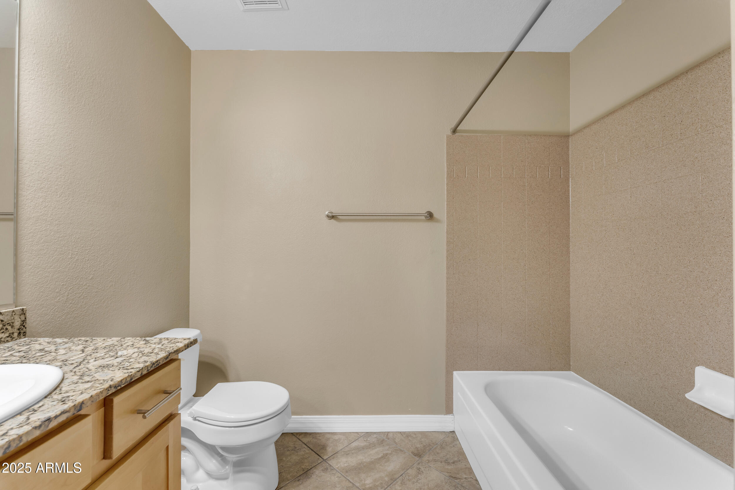 2025 East Campbell Avenue, Unit 140 Phoenix, AZ 85016 - Photo 32 of 52 a bathroom with a granite countertop toilet and a sink