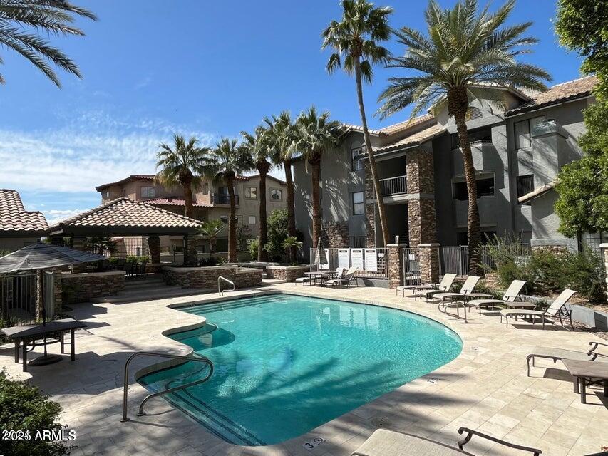2025 East Campbell Avenue, Unit 140 Phoenix, AZ 85016 - Photo 38 of 52 a view of a patio with swimming pool table and chairs