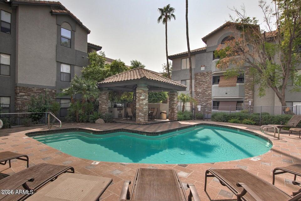 2025 East Campbell Avenue, Unit 140 Phoenix, AZ 85016 - Photo 42 of 52 a view of a house with a yard patio and swimming pool
