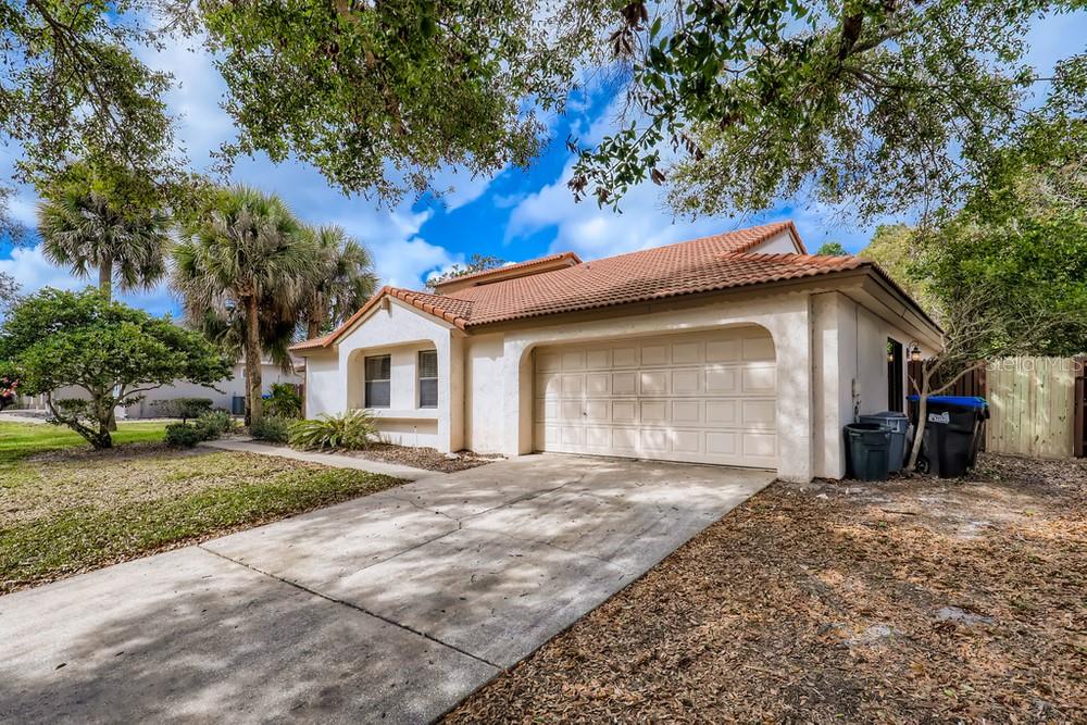 7443 Sparkling Lake Road Orlando, FL 32819 - Photo 1 of 1 a front view of a house with a yard