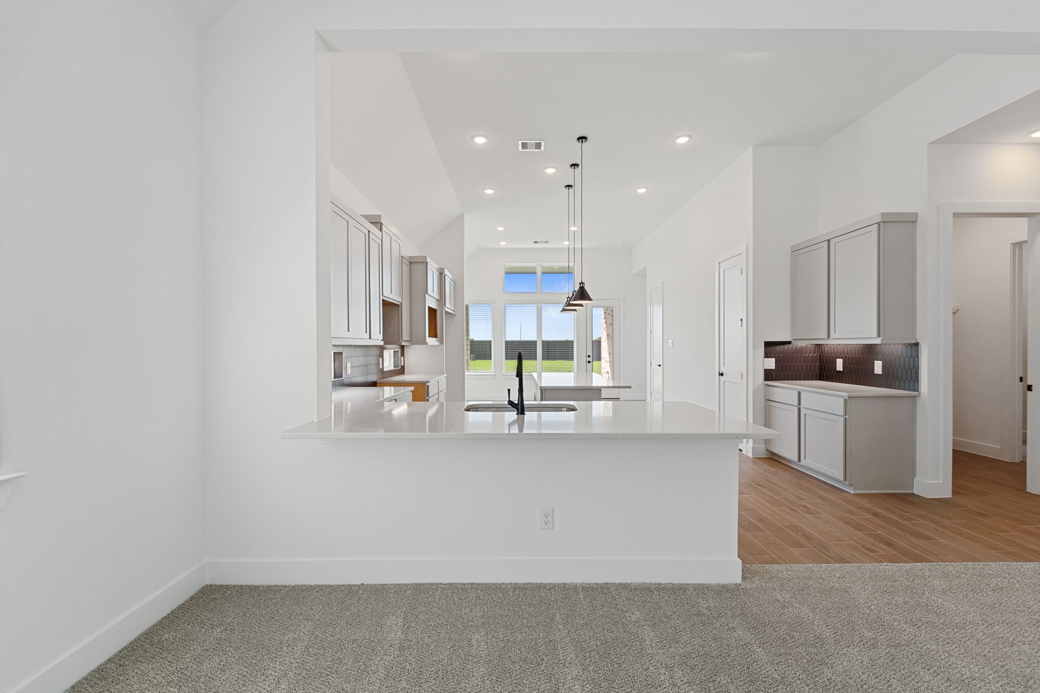 207 Blue River Trail Rosenberg, TX 77471 - Photo 4 of 38 a large white kitchen with a large window and stainless steel appliances