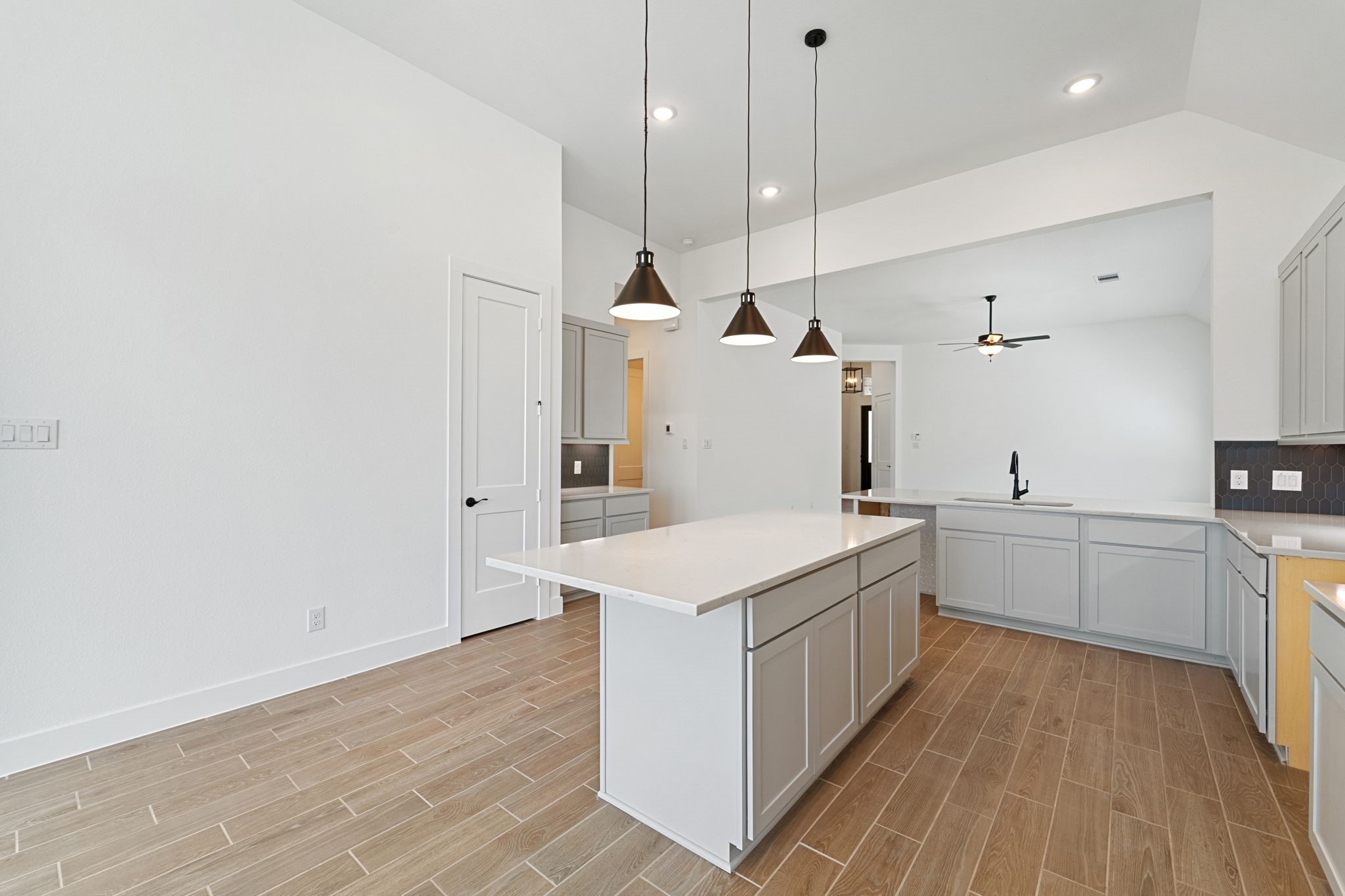 207 Blue River Trail Rosenberg, TX 77471 - Photo 5 of 38 a kitchen with a sink stove and wooden floor