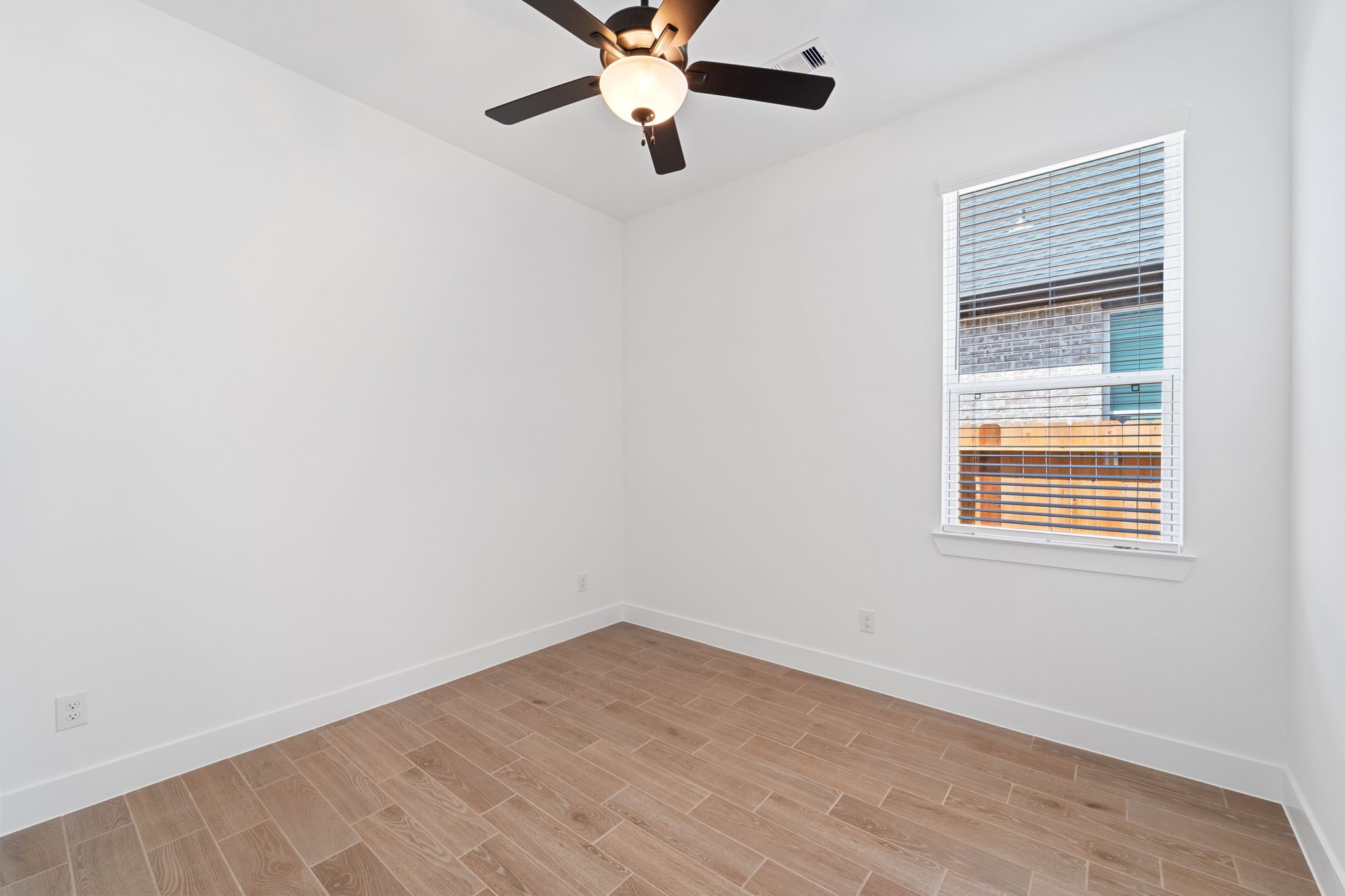 207 Blue River Trail Rosenberg, TX 77471 - Photo 10 of 38 an empty room with a window and a fan
