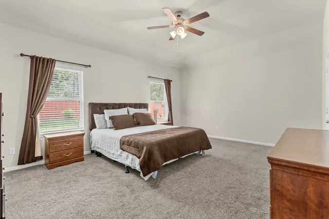 a spacious bedroom with a bed and a window