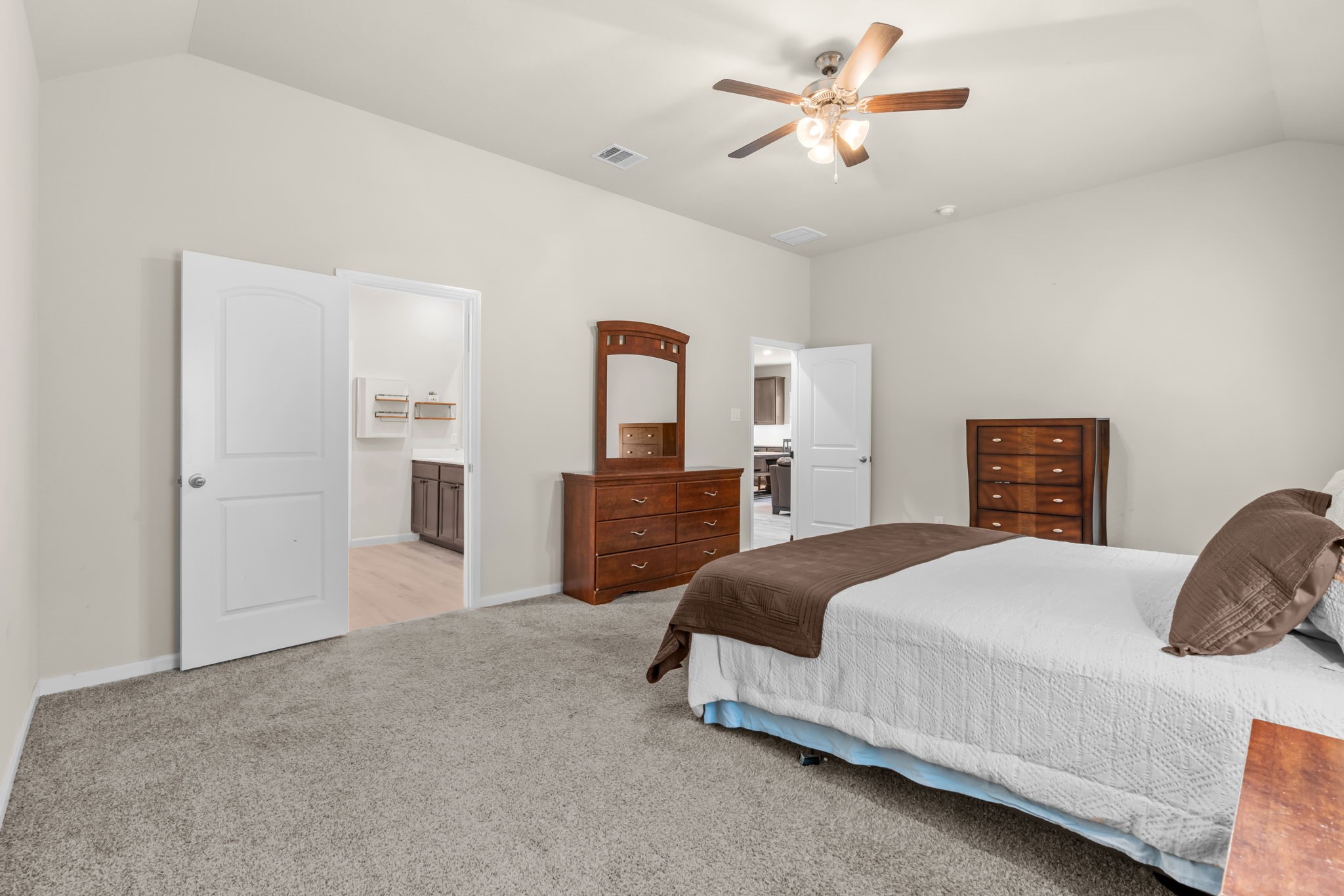 14388 Zion Gate Crossing Conroe, TX 77384 - Photo 14 of 34 a spacious bedroom with a bed and a chandelier