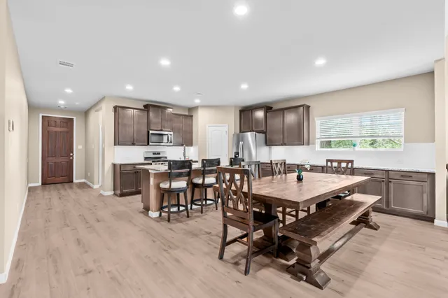 a kitchen with a table and chairs in it