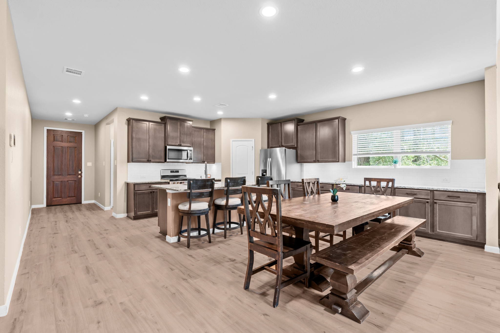 14388 Zion Gate Crossing Conroe, TX 77384 - Photo 5 of 34 a kitchen with a table and chairs in it