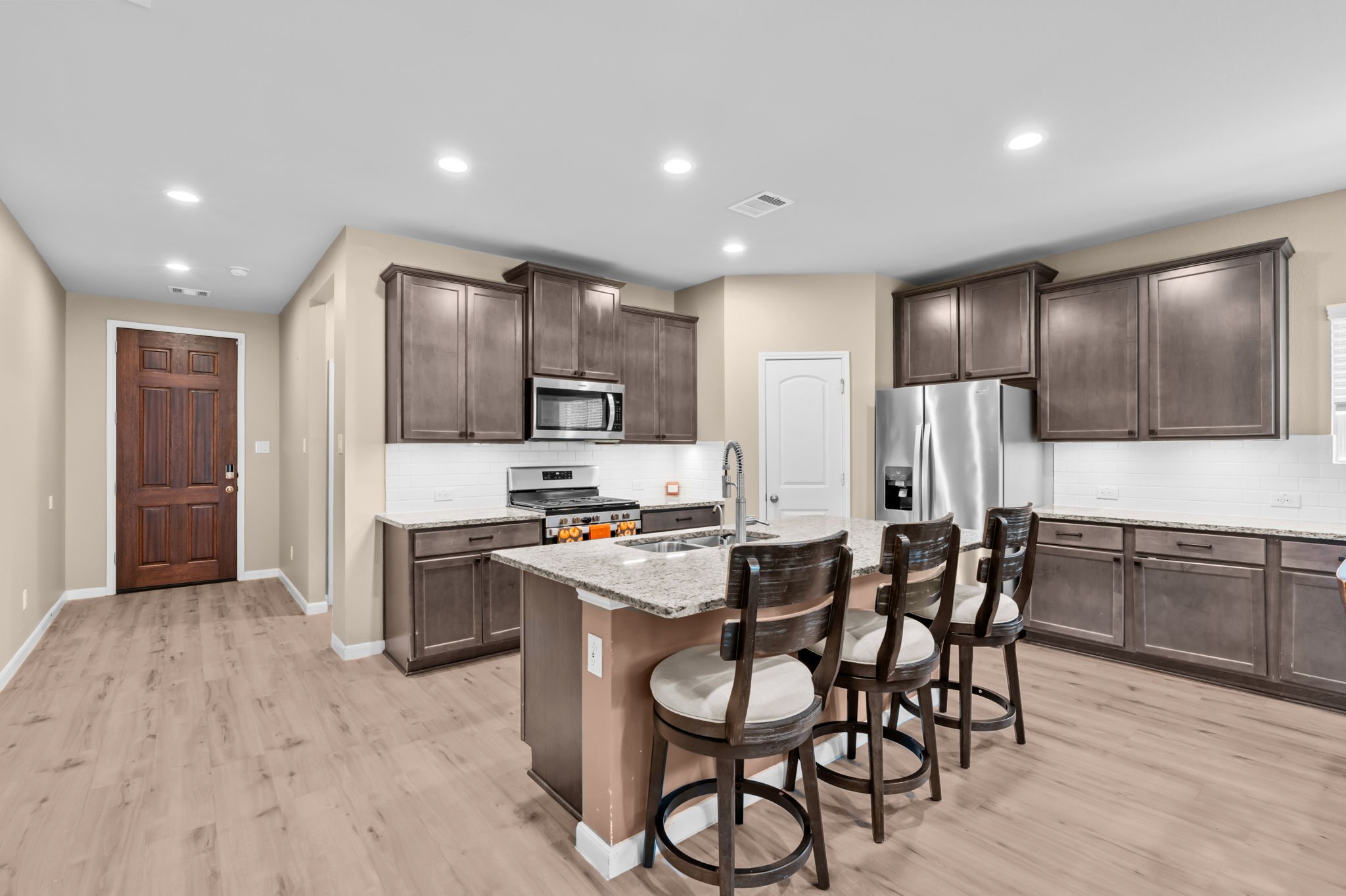 14388 Zion Gate Crossing Conroe, TX 77384 - Photo 6 of 34 a kitchen with stainless steel appliances a refrigerator stove microwave and cabinets