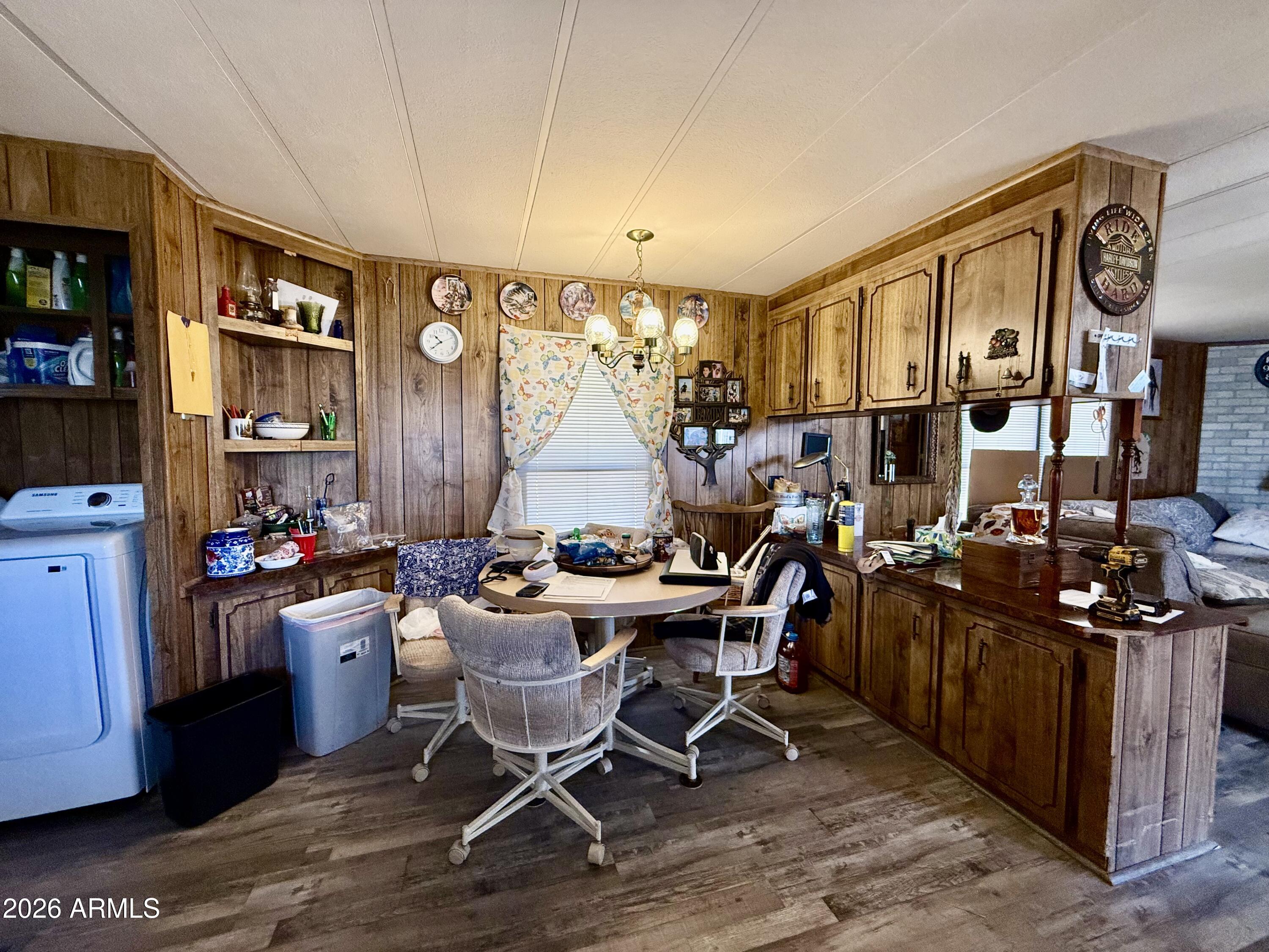 300 Airport Road, Unit 34 Kearny, AZ 85137 - Photo 3 of 18 a view of a dining room with furniture window and wooden floor