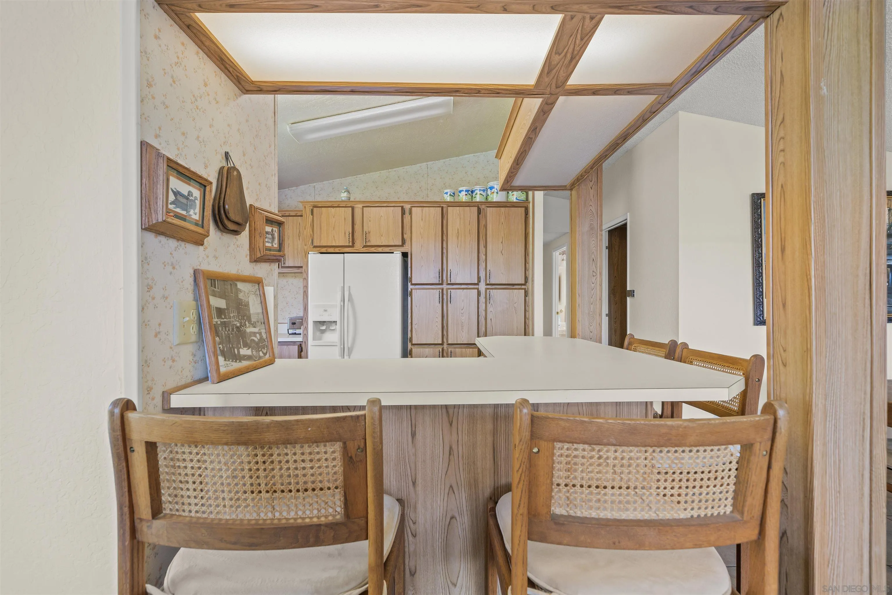2464 Wynola Road Julian, CA 92036 - Photo 28 of 50 a room with a table chairs and a refrigerator
