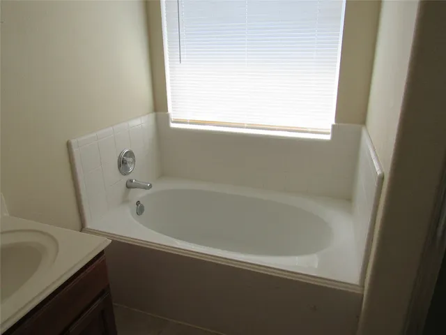 a white bath tub sitting next to a window