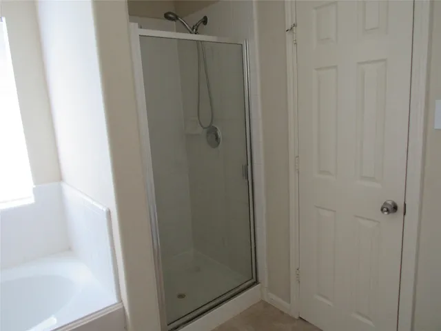 a bathroom with a glass shower door