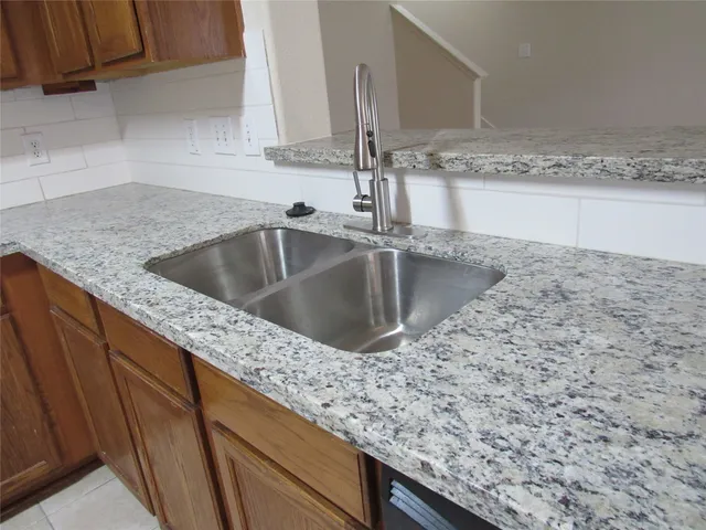 a kitchen with a sink and a counter top