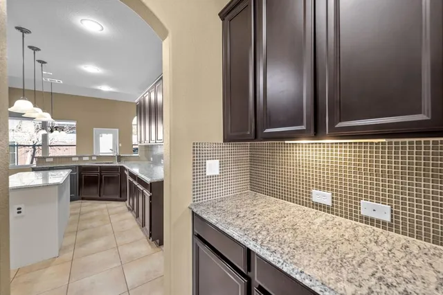 a kitchen with a sink and a refrigerator
