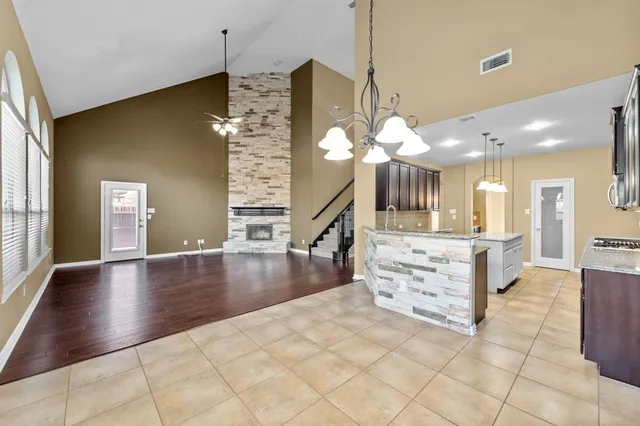 a view of kitchen and hall with chandelier