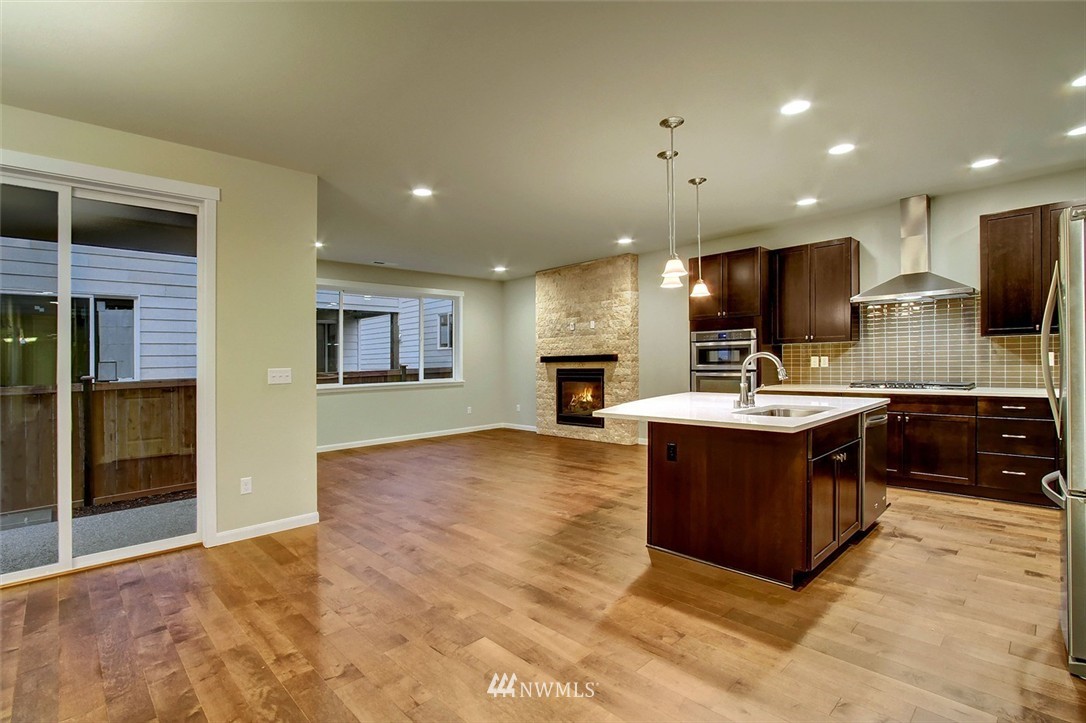 4325 Lot Place Southeast, Unit 14 223 Bothell, WA 98021 - Photo 2 of 14 a kitchen with kitchen island a sink stainless steel appliances and cabinets