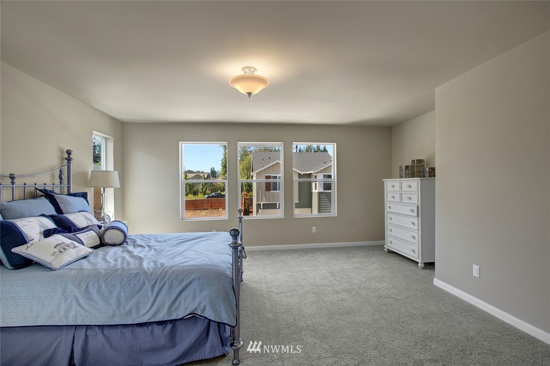4325 Lot Place Southeast, Unit 14 223 Bothell, WA 98021 - Photo 8 of 14 a spacious bedroom with a bed and wooden floor