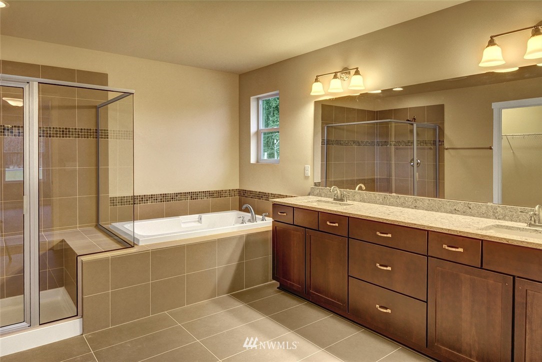 4325 Lot Place Southeast, Unit 14 223 Bothell, WA 98021 - Photo 9 of 14 a spacious bathroom with a tub sink shower and mirror