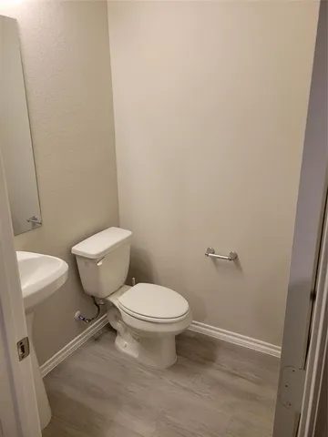 a white toilet sitting next to a white sink