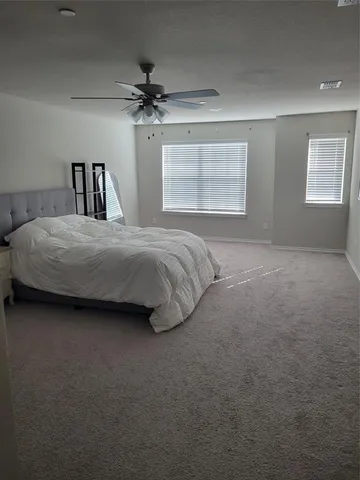 a bedroom with a bed and window