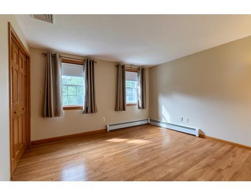 34 Brox Road Dracut, MA 01826 - Photo 17 of 35 a view of an empty room with window and wooden floor