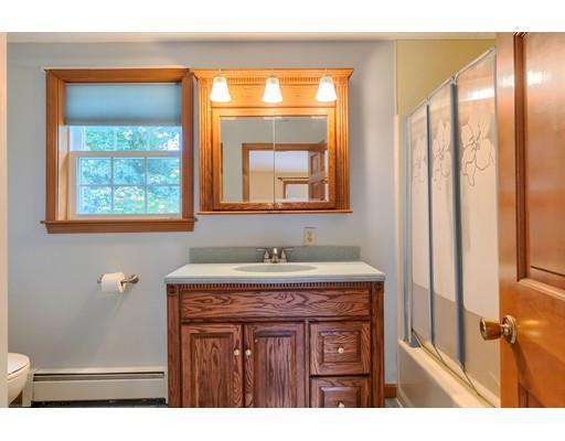 34 Brox Road Dracut, MA 01826 - Photo 20 of 35 a bathroom with a granite countertop sink a mirror and a shower