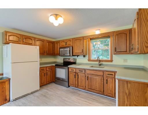 34 Brox Road Dracut, MA 01826 - Photo 3 of 35 a kitchen with stainless steel appliances granite countertop a refrigerator a sink dishwasher a stove with wooden cabinets and wooden floor