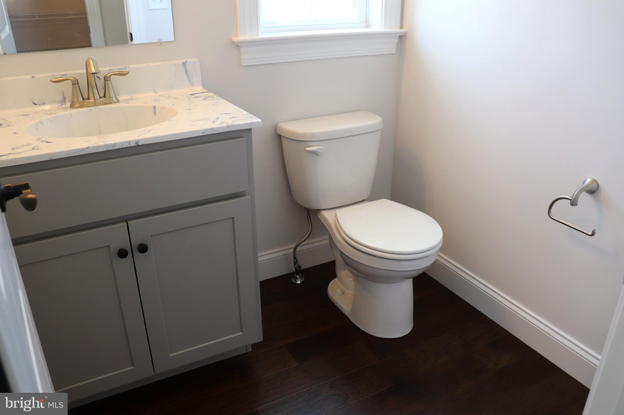 1029 Strafford Place, Unit 55 Lancaster, PA 17601 - Photo 17 of 40 a bathroom with a toilet sink and mirror