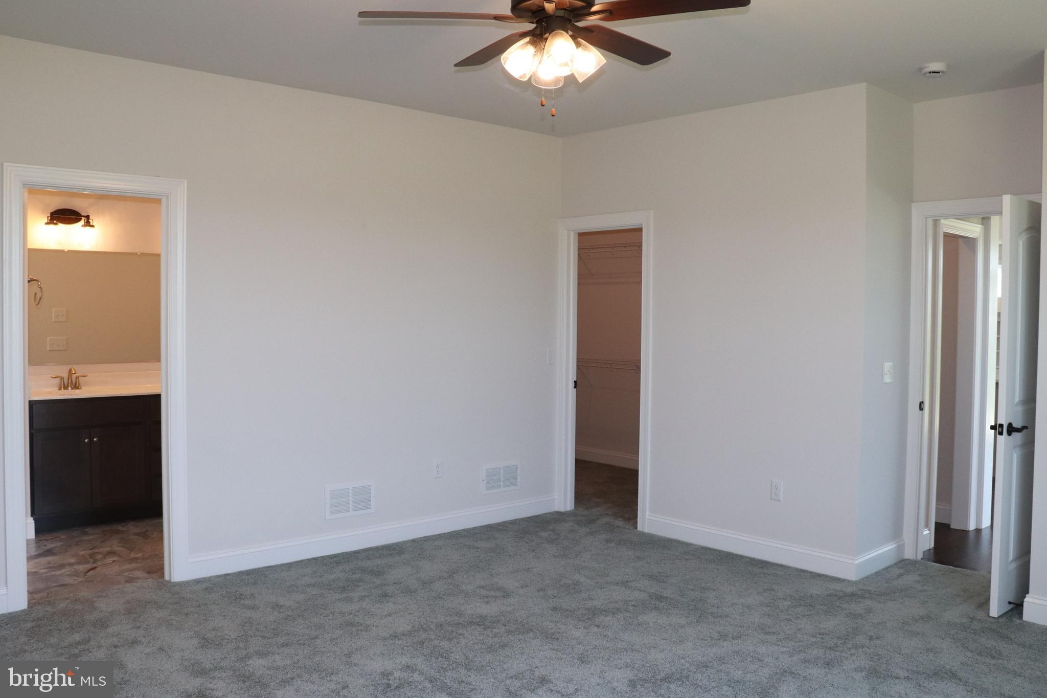 1029 Strafford Place, Unit 55 Lancaster, PA 17601 - Photo 20 of 40 an empty room with a chandelier fan and a bathroom