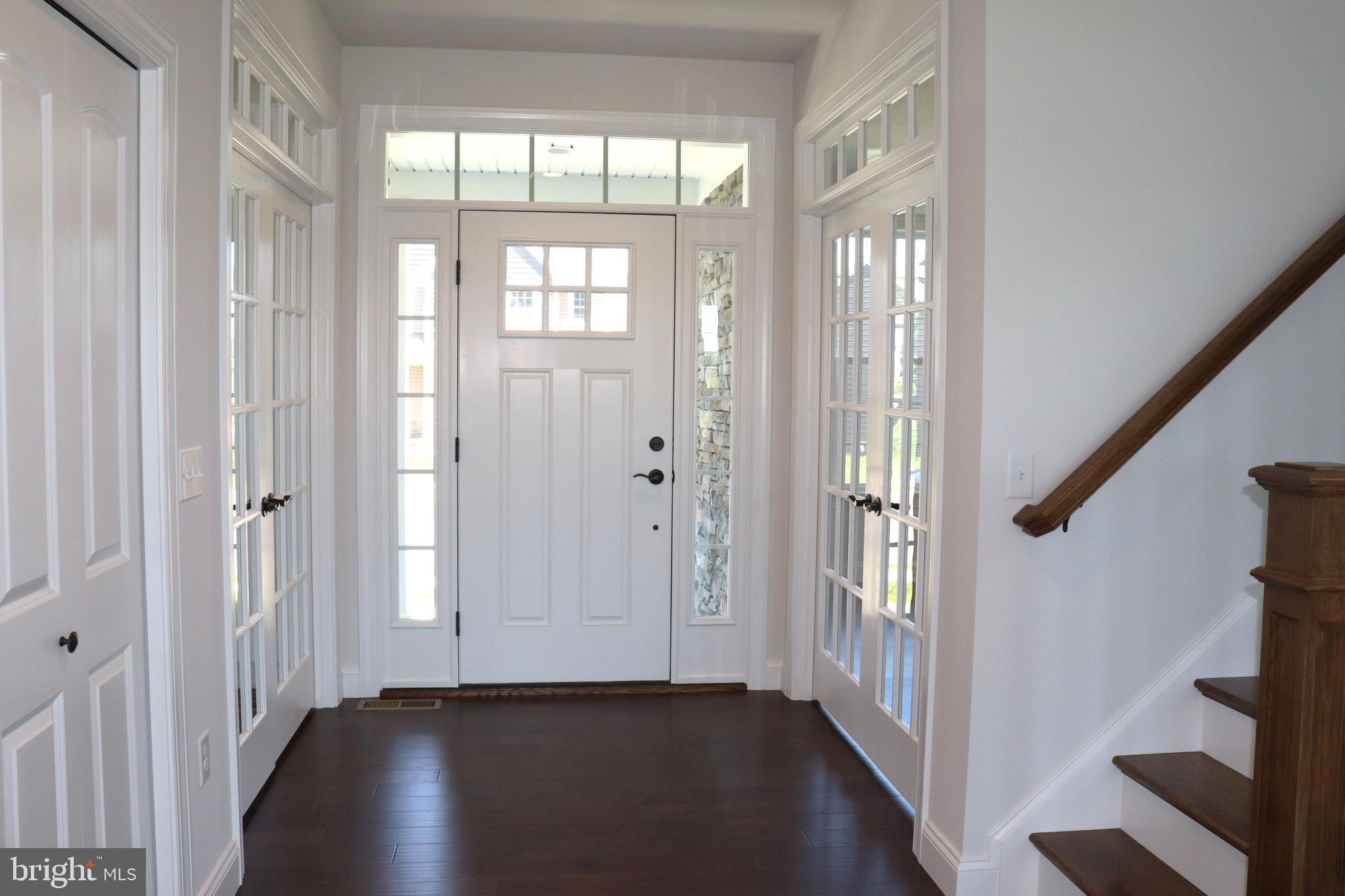 1029 Strafford Place, Unit 55 Lancaster, PA 17601 - Photo 3 of 40 a view of a hallway with wooden floor and stairs